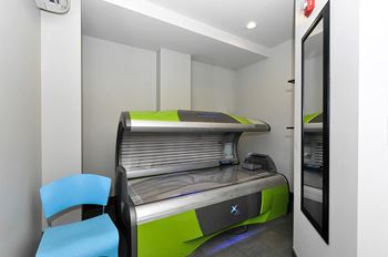 a room with an open printer and two blue chairs at Bluestone Lofts, Duluth, 55803